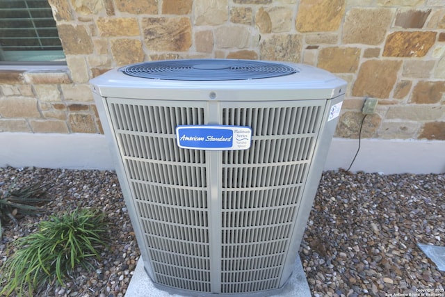 exterior details with central AC and stone siding