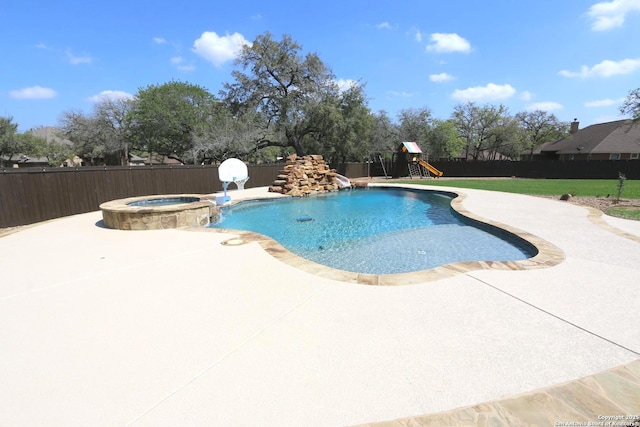 view of pool with a playground, fence, a patio, and a pool with connected hot tub