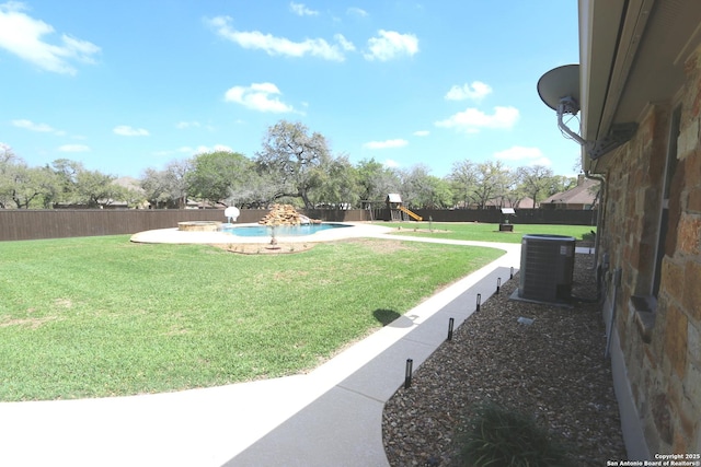 view of yard with central air condition unit, a fenced in pool, a playground, and a fenced backyard