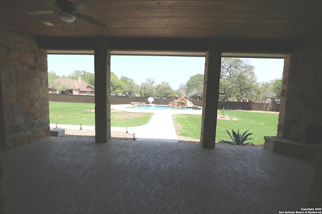 exterior space featuring wood ceiling, carpet, and a ceiling fan