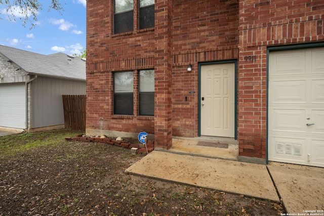 9911 Alexa Pl, San Antonio, TX 78251 - view of exterior entry with brick siding and a garage