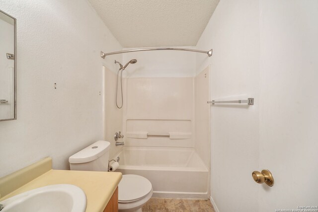 9911 Alexa Pl, San Antonio, TX 78251 - bathroom featuring a textured ceiling, toilet, shower / bathing tub combination, and vanity
