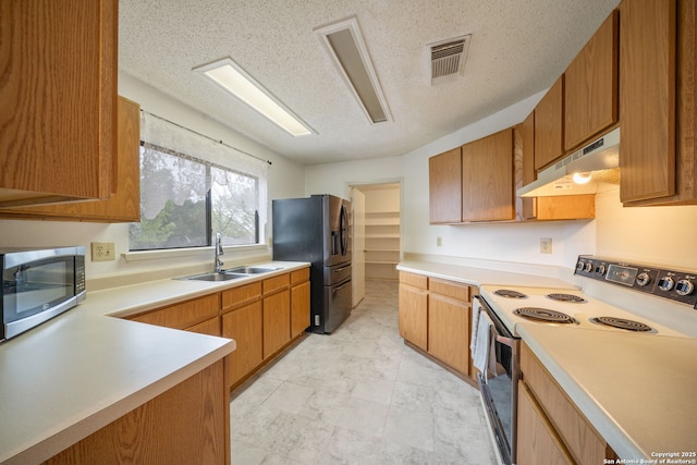 9911 Alexa Pl, San Antonio, TX 78251 - kitchen featuring light countertops, a sink, appliances with stainless steel finishes, under cabinet range hood, and visible vents