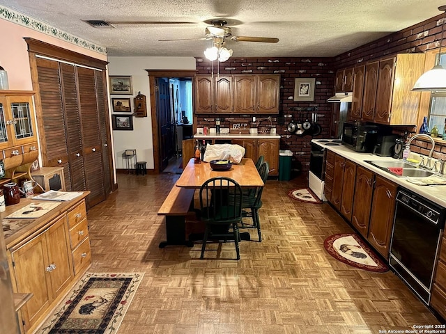 kitchen featuring a sink, visible vents, light countertops, and black appliances