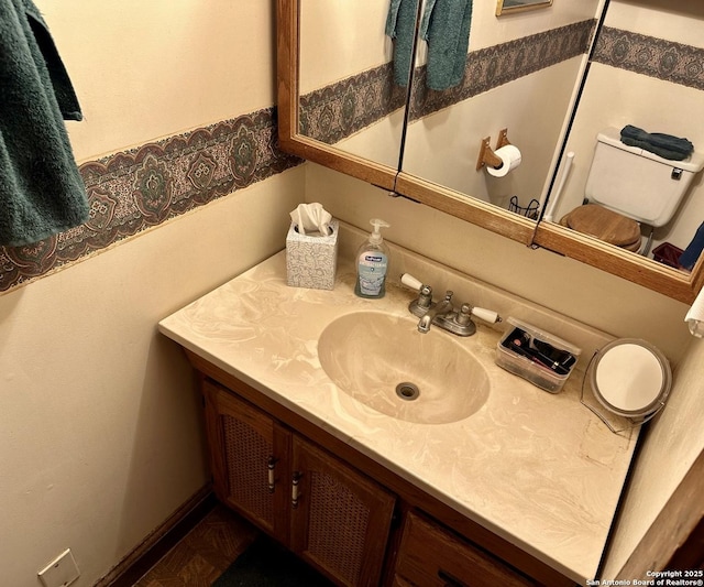 bathroom with toilet and vanity