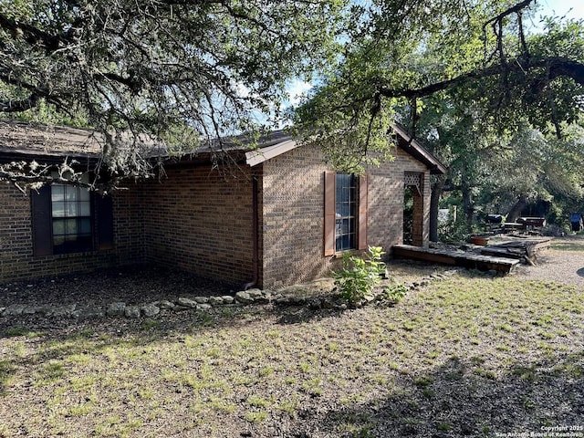 view of property exterior with brick siding