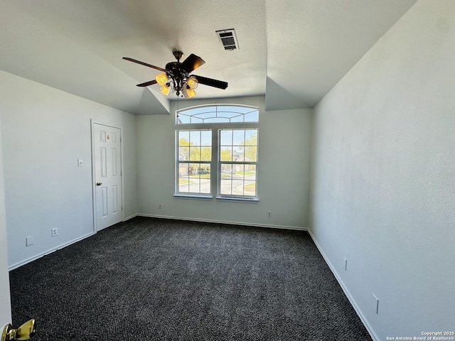 1064 Maltese Ln, San Antonio, TX 78260 - spare room with a textured ceiling, visible vents, a ceiling fan, dark carpet, and vaulted ceiling