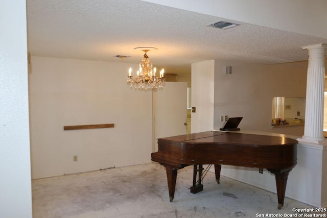 interior space featuring a textured ceiling, visible vents, ornate columns, concrete floors, and a notable chandelier