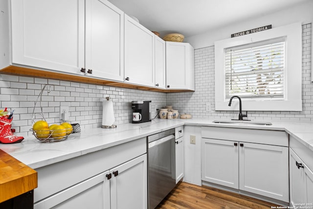 314 Trail, San Antonio, TX 78212 - kitchen with dishwasher, tasteful backsplash, white cabinetry, a sink, and light stone counters
