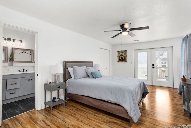 314 Trail, San Antonio, TX 78212 - bedroom featuring french doors, access to outside, a sink, connected bathroom, and wood finished floors
