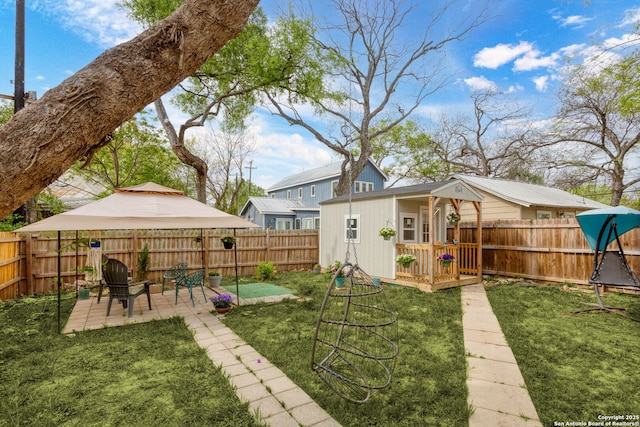 314 Trail, San Antonio, TX 78212 - view of yard featuring an outdoor structure, a fenced backyard, and a patio