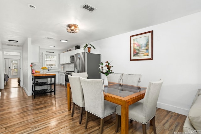 314 Trail, San Antonio, TX 78212 - dining room with light wood-style flooring, baseboards, and visible vents