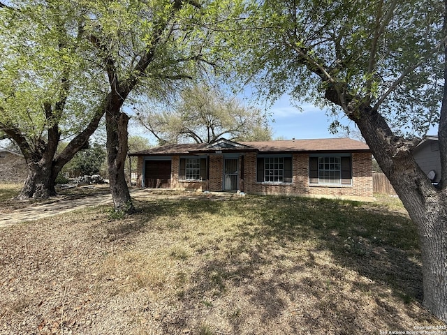 5119 Village Ct, San Antonio, TX 78218 - single story home featuring a front yard, an attached garage, and brick siding