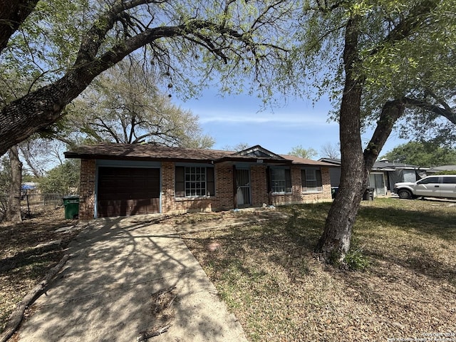 5119 Village Ct, San Antonio, TX 78218 - ranch-style home featuring an attached garage, brick siding, and concrete driveway