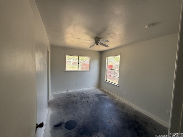 5119 Village Ct, San Antonio, TX 78218 - empty room featuring a ceiling fan, concrete flooring, and baseboards