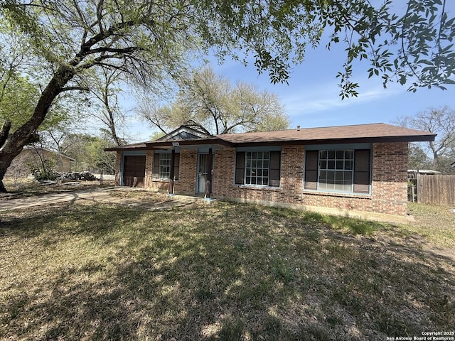 5119 Village Ct, San Antonio, TX 78218 - single story home with brick siding, a front yard, fence, and an attached garage