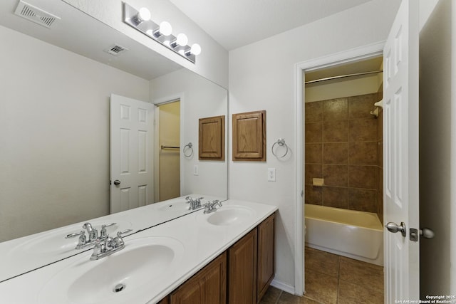 bathroom with tile patterned floors, visible vents, and a sink