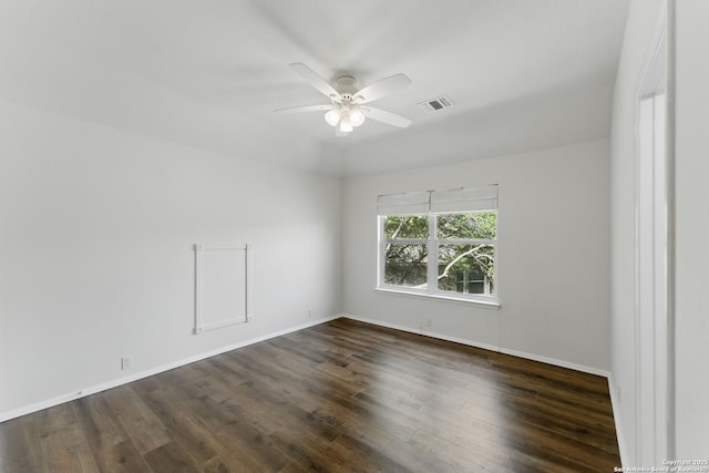 unfurnished room featuring visible vents, baseboards, a ceiling fan, and dark wood-style floors