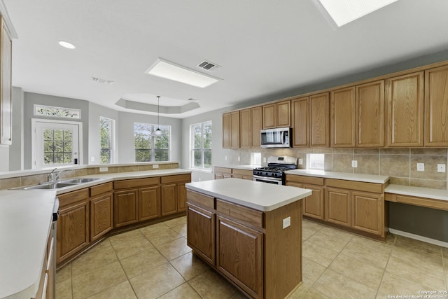 kitchen with a center island, a sink, visible vents, and stainless steel appliances