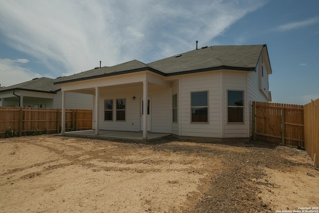 6003 Cienna Cv, San Antonio, TX 78222 - back of property featuring a patio area, a fenced backyard, and roof with shingles