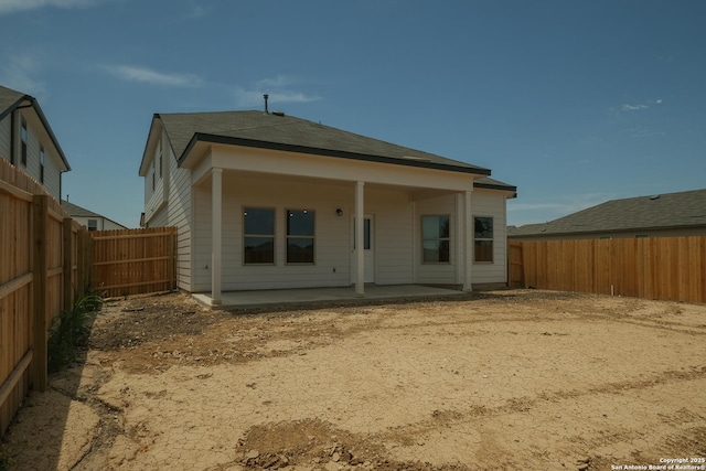 6003 Cienna Cv, San Antonio, TX 78222 - back of house featuring a fenced backyard, a patio, and a shingled roof