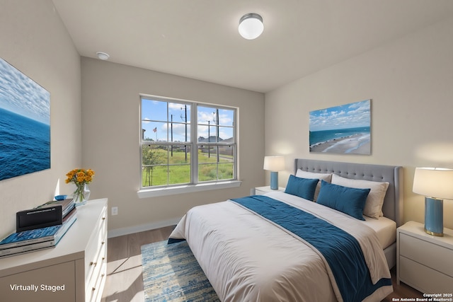 bedroom featuring light wood-style flooring and baseboards