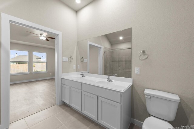 full bath featuring tile patterned flooring, toilet, a ceiling fan, a sink, and a stall shower
