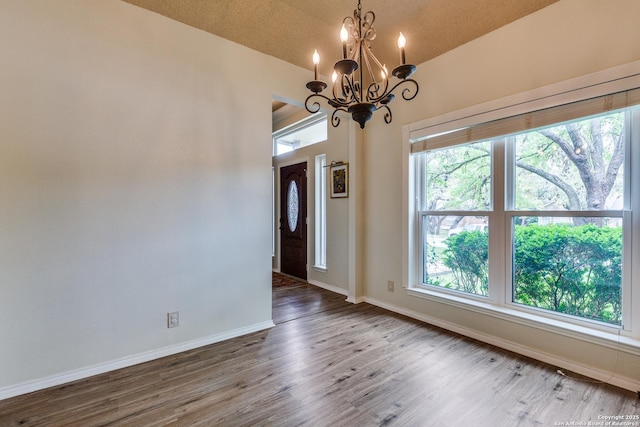 2312 Encino Xing, San Antonio, TX 78259 - entrance foyer with baseboards, vaulted ceiling, wood finished floors, and an inviting chandelier