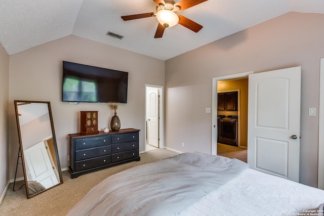 2312 Encino Xing, San Antonio, TX 78259 - bedroom featuring vaulted ceiling, light carpet, a walk in closet, a textured ceiling, and visible vents