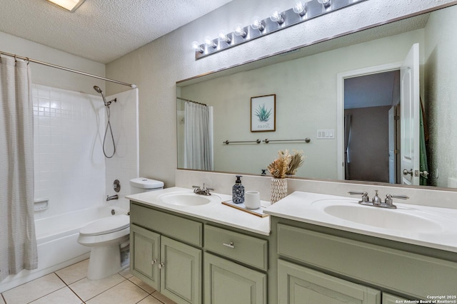 2312 Encino Xing, San Antonio, TX 78259 - bathroom with double vanity, tile patterned flooring, a sink, and a textured ceiling