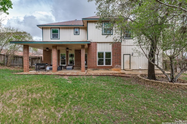 2312 Encino Xing, San Antonio, TX 78259 - back of property with fence, a patio, a ceiling fan, brick siding, and a lawn