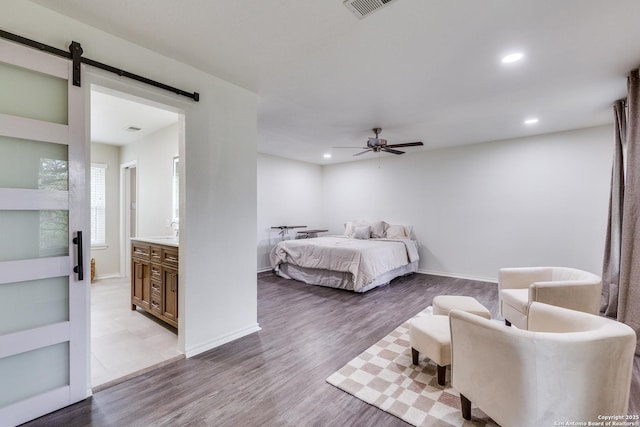 2312 Encino Xing, San Antonio, TX 78259 - bedroom with a barn door, wood finished floors, and recessed lighting