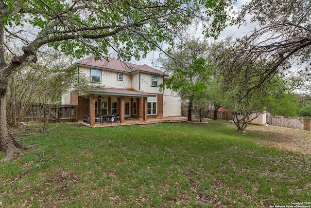 2312 Encino Xing, San Antonio, TX 78259 - rear view of house with a lawn, brick siding, a fenced backyard, and a patio area