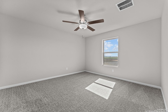 unfurnished room with visible vents, carpet, and ceiling fan
