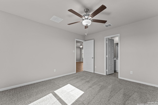 unfurnished bedroom with carpet flooring, baseboards, and visible vents