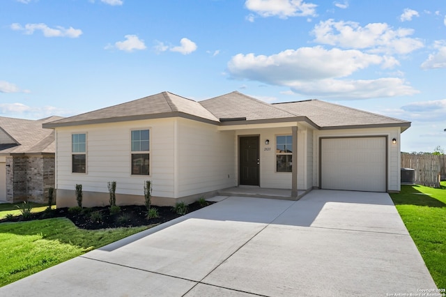 view of front of property with a garage, fence, driveway, and a front yard