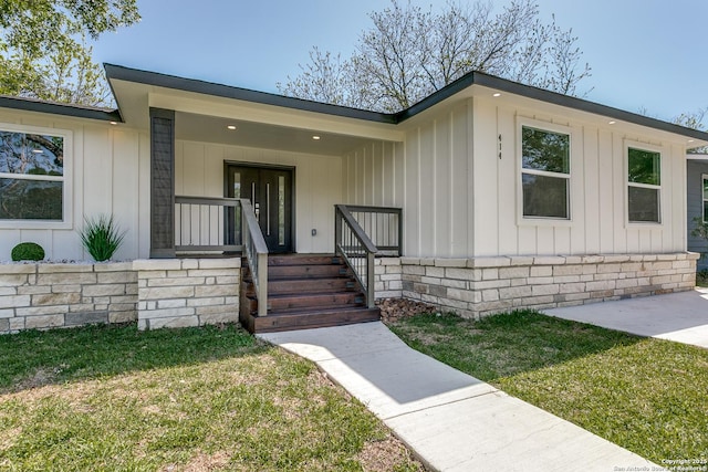 414 Devonshire, San Antonio, TX 78209 - entrance to property featuring board and batten siding, covered porch, and a lawn