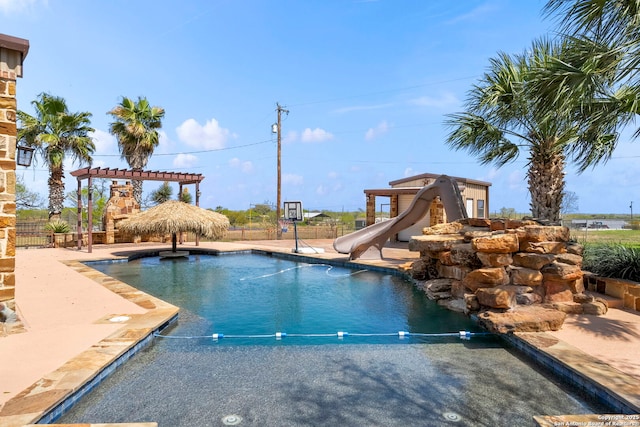 8745 Kirkner, San Antonio, TX 78263 - view of pool with fence, a water slide, a fenced in pool, a pergola, and a patio area