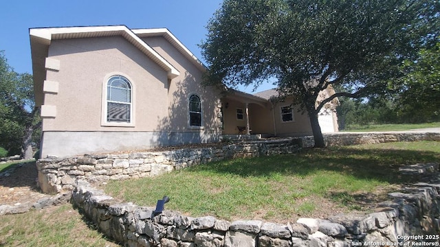 260 Campbell, Canyon Lake, TX 78133 - view of front of home featuring a garage, a front yard, and stucco siding
