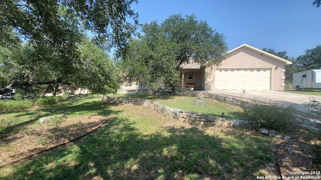 260 Campbell, Canyon Lake, TX 78133 - view of front of property featuring a front lawn, stucco siding, a garage, and concrete driveway