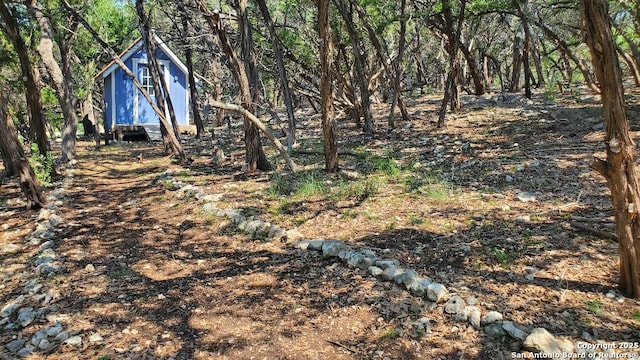 260 Campbell, Canyon Lake, TX 78133 - view of yard featuring an outbuilding, a forest view, and a storage unit