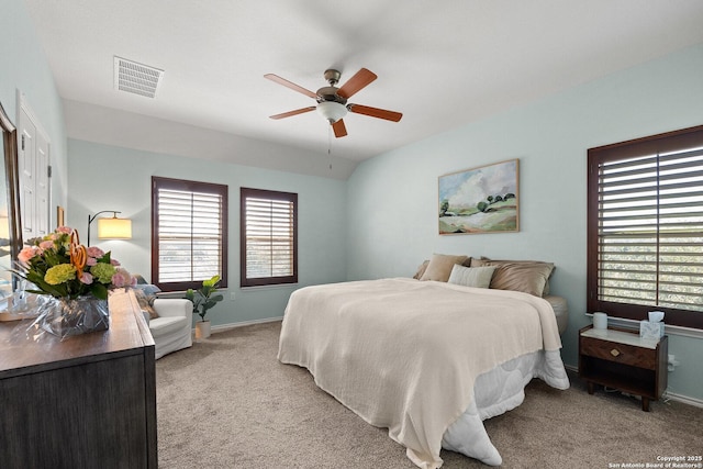 carpeted bedroom with a ceiling fan, baseboards, and visible vents