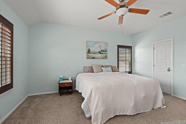 bedroom with vaulted ceiling, carpet, baseboards, ceiling fan, and visible vents