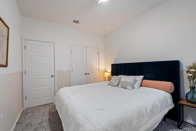 bedroom featuring baseboards, carpet, a closet, and visible vents