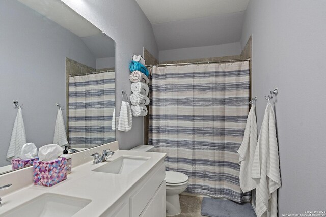 bathroom with a shower with curtain, double vanity, toilet, and a sink