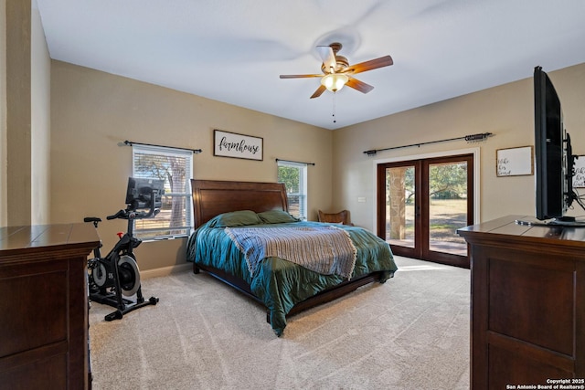 bedroom featuring light colored carpet, ceiling fan, baseboards, and access to exterior