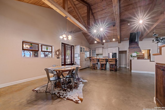dining area with concrete flooring, beamed ceiling, wood ceiling, baseboards, and high vaulted ceiling