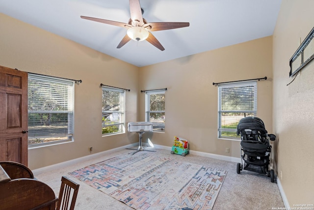 interior space featuring baseboards, a ceiling fan, and carpet flooring