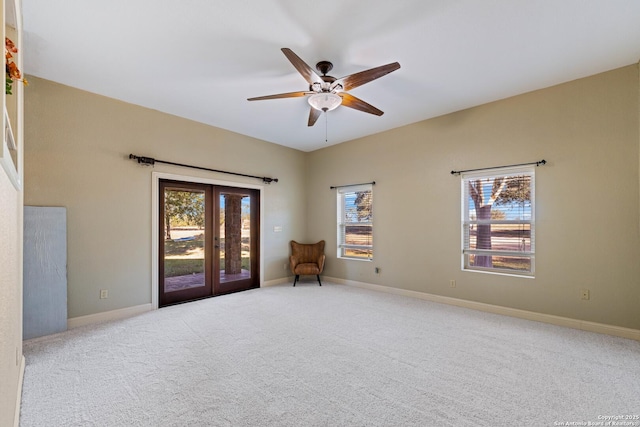 unfurnished room with baseboards, a ceiling fan, french doors, and carpet floors