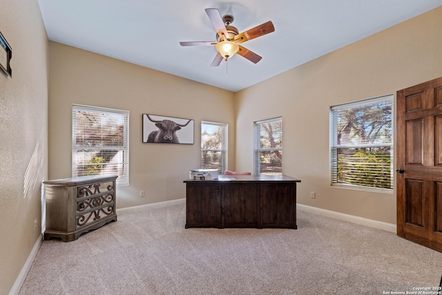 office area featuring light carpet, baseboards, and ceiling fan